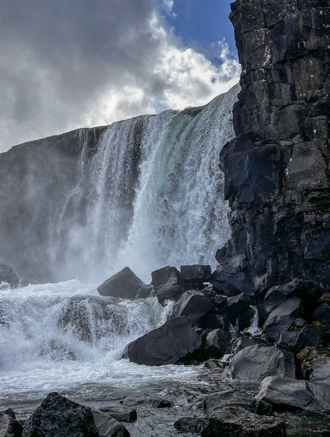 Öxarárfoss waterfall crashing onto basalt boulders, Þingvellir, Iceland